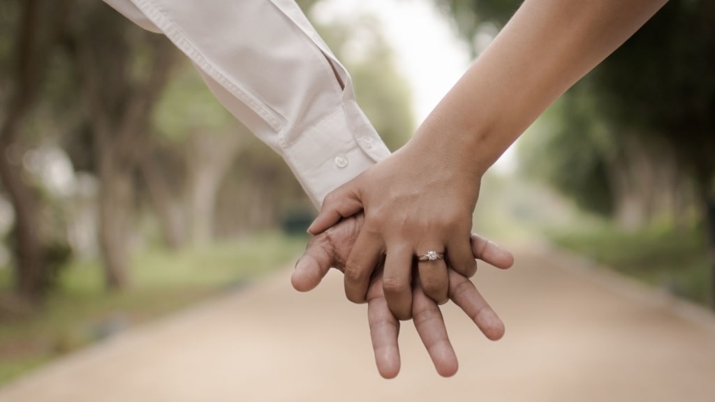 married couple holding hands